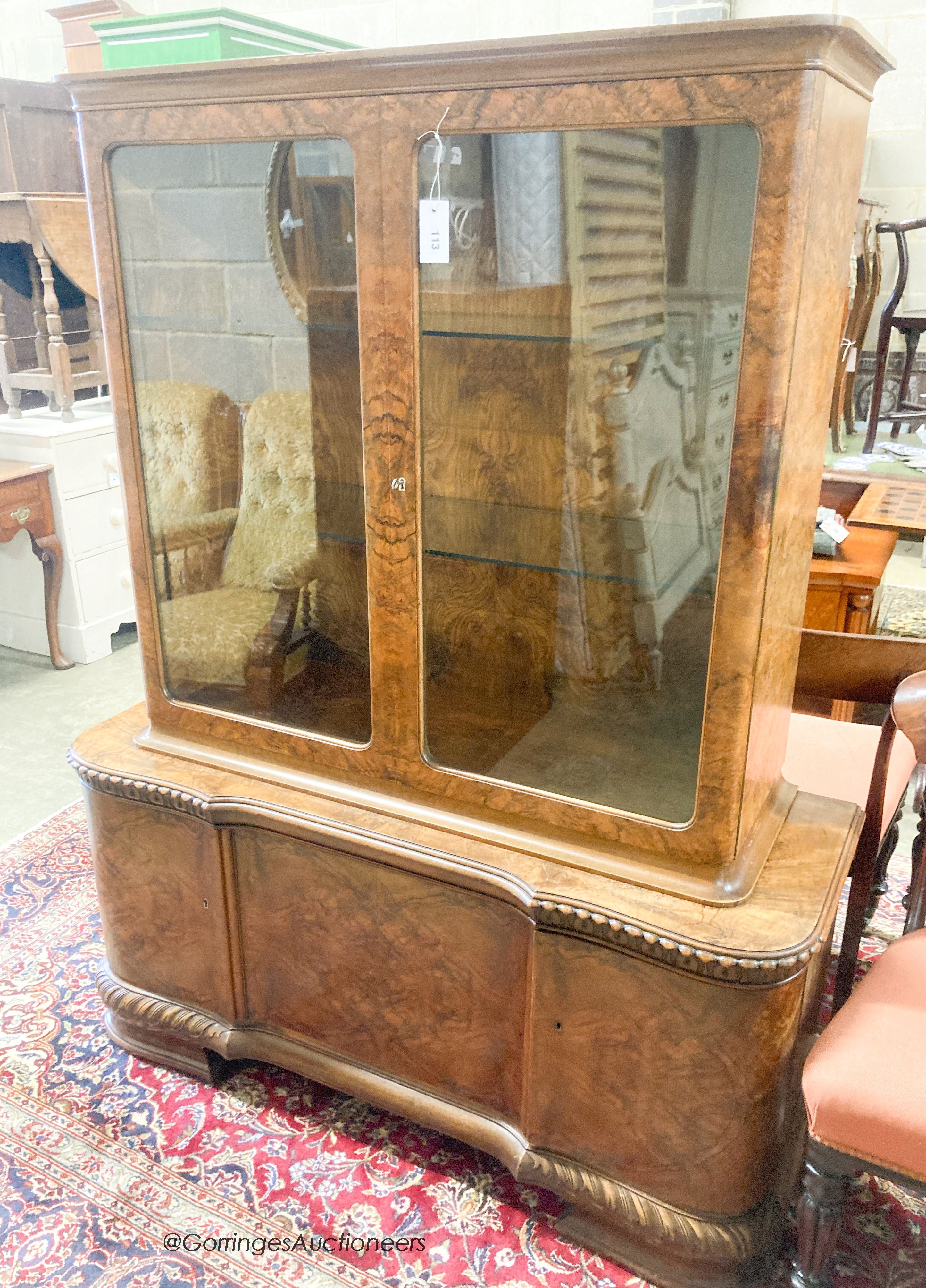 A 1930's walnut veneered china display cabinet combined cupboard, length 130cm, depth 46cm, height 165cm